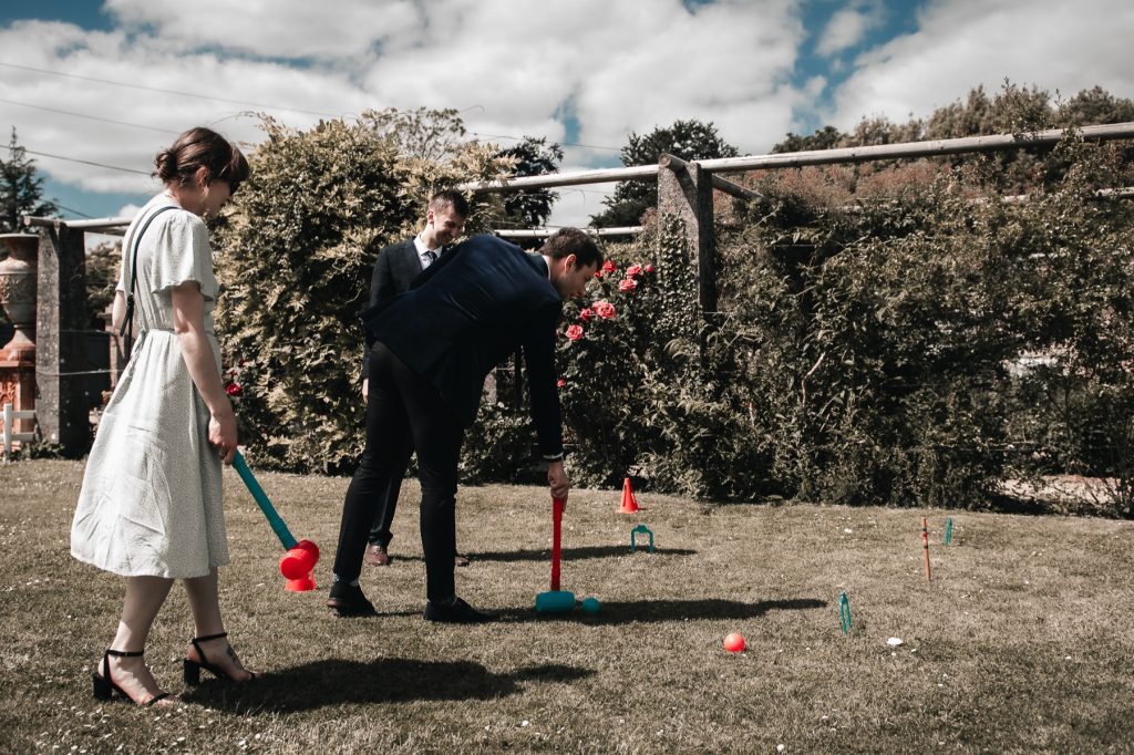 Guests playing giant lawn games in the sunshine